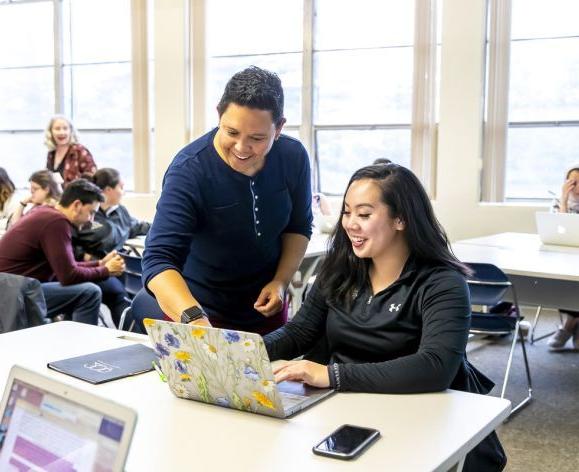 student and professor interacting in classroom